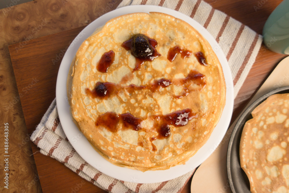 Pancake week. Preparation of dough for baking delicious and ruddy pancakes from the ingredients eggs, flour, butter and milk. Maslenitsa traditional Russian festival meal.