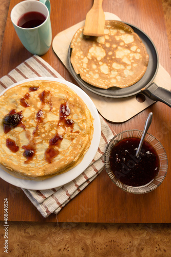 Pancake week. Preparation of dough for baking delicious and ruddy pancakes from the ingredients eggs, flour, butter and milk. Maslenitsa traditional Russian festival meal.