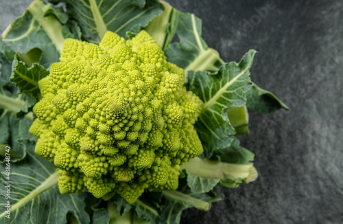 Romanesco broccoli head on a dark stone surface, cabbage, close up,  fibonacci sequence, for those who love mathematics