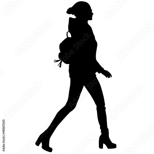 Black silhouette of slender woman in trousers, boots and backpack