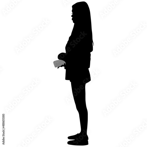 Black silhouette of slender woman in trousers with long hair with phone in her hand