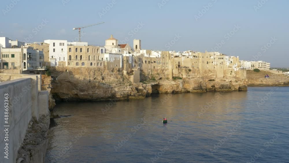 The Beautiful Cliffs of Polignano a Mare Coastal Town Bathing in the Golden Hour Morning Light.