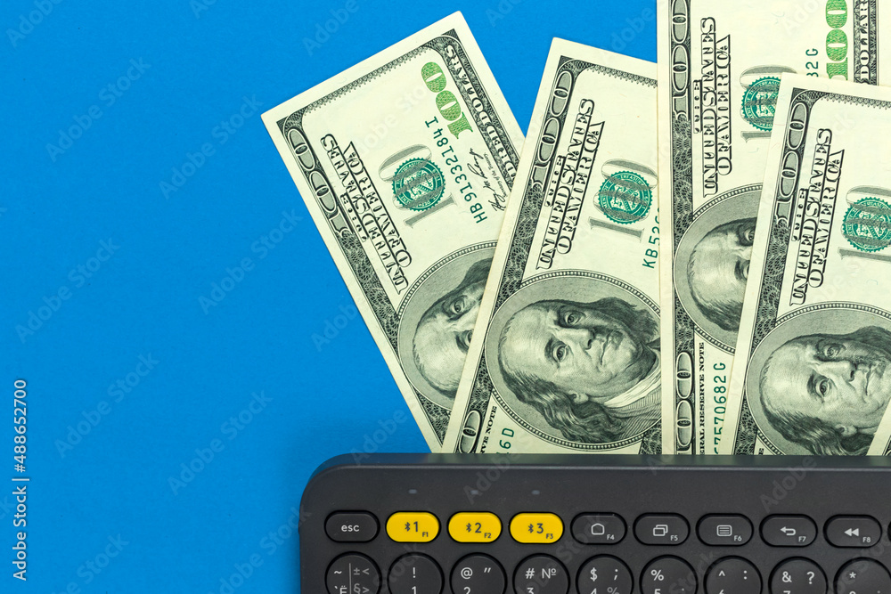 Keyboard and dollar bills. Freelance concept, concept of work at home, making money, workspace top view, flat lay design, copy space photo Keyboard and dollar bills. Freelance concept, concept of work at home, making money, workspace top view, flat lay design, copy space photo