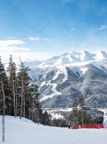 Beautiful landscape of the Arkhyz ski resort with mountains, snow, forest, skiers and snowboarders  on a sunny winter day. Caucasus  Mountains, Russia © Kufotos