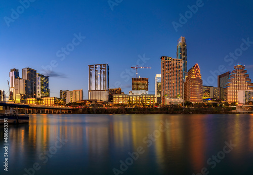 Panorama of downtown Austin Texas across Lady Bird Lake at sunset golden hour