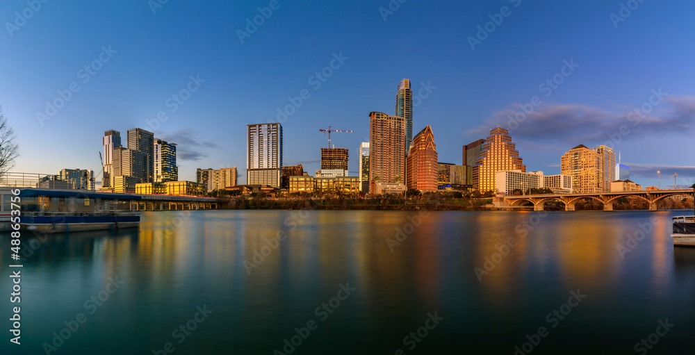 Panorama of downtown Austin Texas across Lady Bird Lake at sunset golden hour