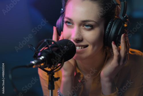 Young woman working at the radio station photo