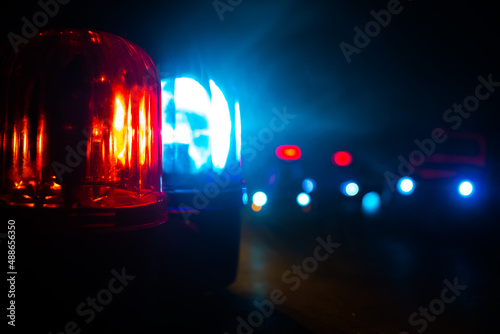 Police car blue and red round vintage siren in dark. Rotating retro style police siren in dark. © zef art