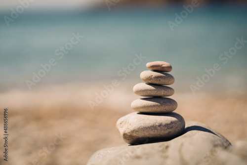 Pyramid stones balance on the sand of the beach. Zen balance  minimalism  harmony and peace. Selective focus