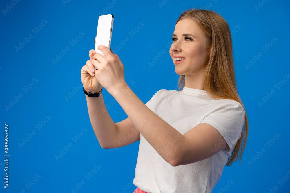 Portrait of a young woman using mobile phone over color background. Portrait of a young woman using mobile phone over color background.