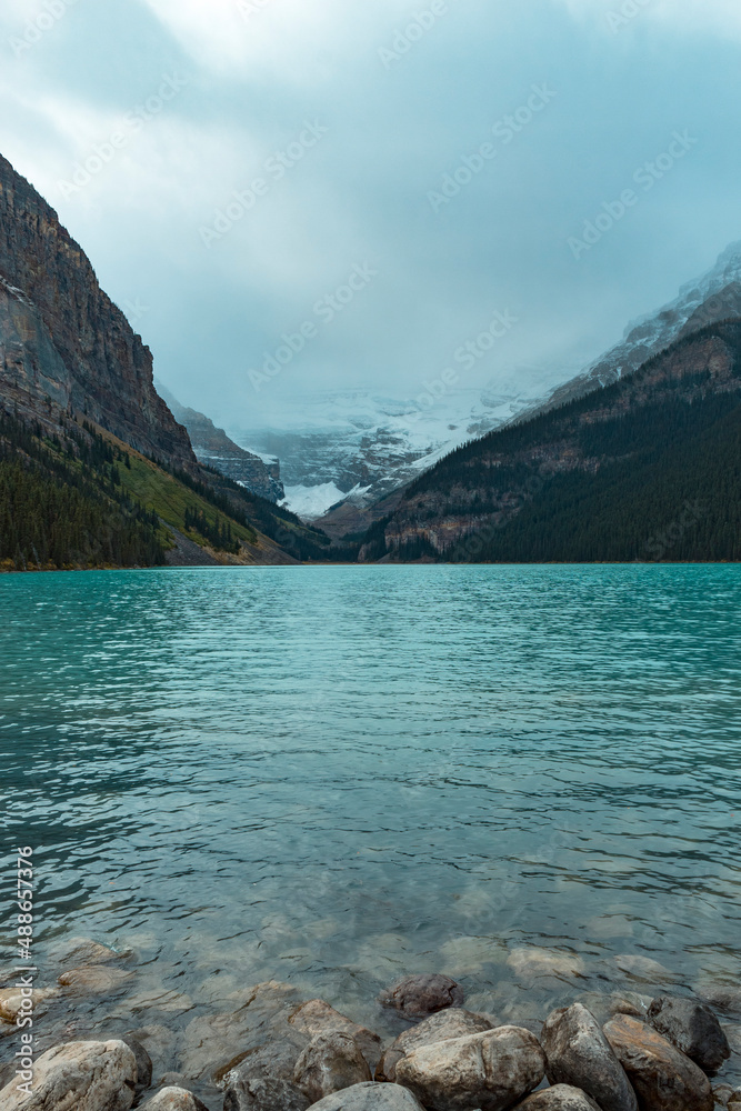 stormy overcast day at Lake Louis Iconic mountain shot with crystal clear teal water