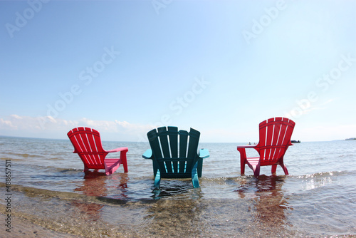 Chairs on a beach at the edge of water
