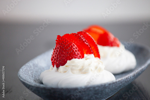 sweet mini cake Pavlova with strawberries whipped cream and meringue