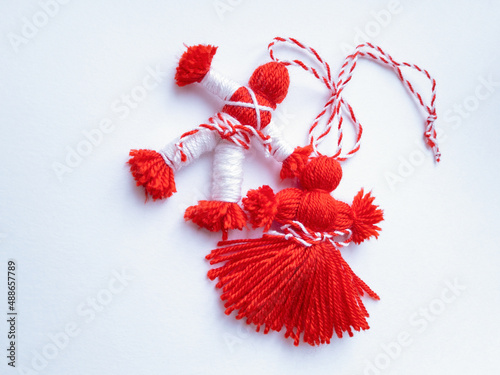 Traditional red and white dolls, symbols of the beginning of spring in the Balkan countries. Bulgarian martenitsa. Red and white woolen threads. photo