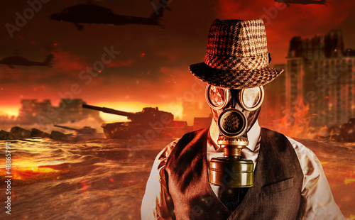 Portrait photo of post apocalyptic male citizen in formal outfit, hat and gas mask standing on destroyed city nuclear war wasteland. photo
