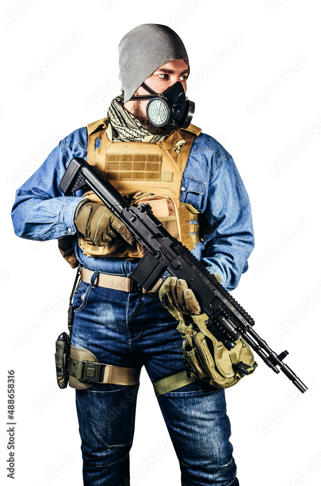 Isolated photo of urban soldier in tactical military outfit and gas mask standing with rifle and gas mask white background.