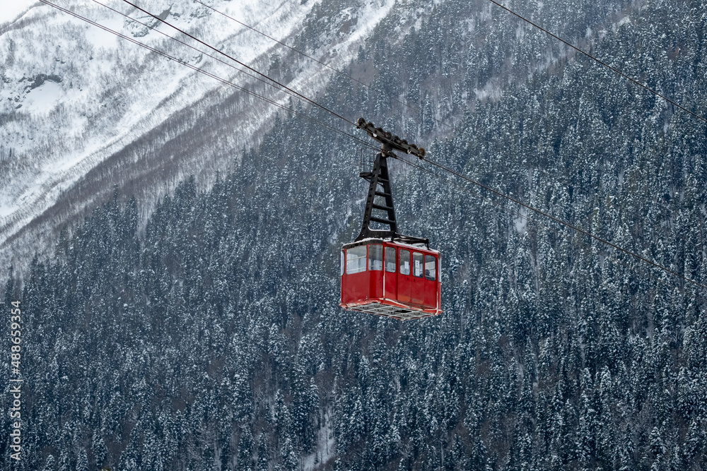 Cableway in the mountains. Cabin with people on the background of the mountains. Cableway in the mountains. Cabin with people on the background of the mountains.