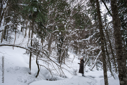 Girl walking in the snowy forest.