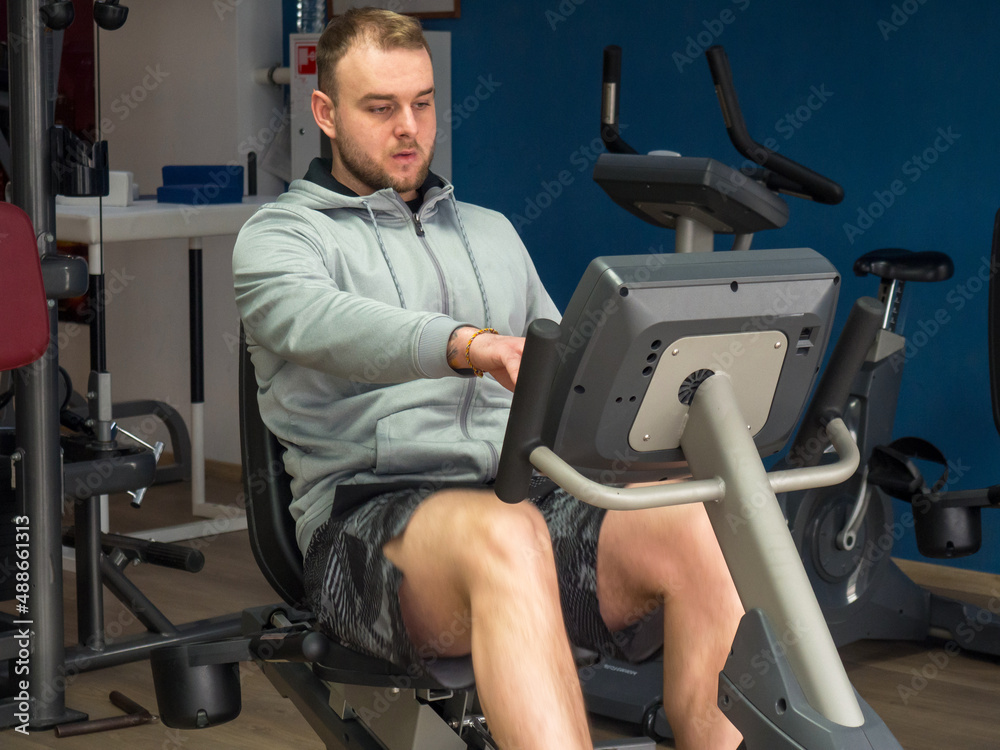 guy on an exercise bike in the gym. Fitness, workout and healthy lifestyle guy on an exercise bike in the gym. Fitness, workout and healthy lifestyle