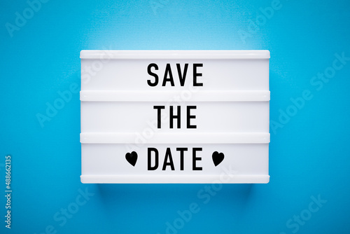 Quadro su tela Lightbox on blue background: Save the Date
