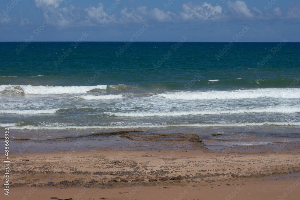 view from the sand from the beach to the sea on a sunny day view from the sand from the beach to the sea on a sunny day