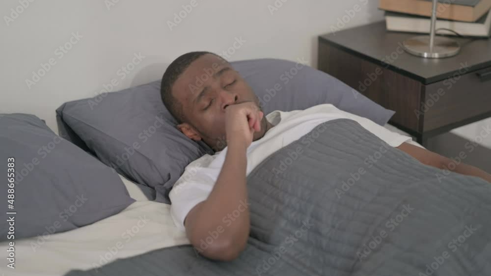 African Man Coughing while Sleeping in Bed African Man Coughing while Sleeping in Bed