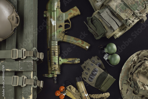 military ammunition top view of a grenade box, rifle, grenades, bulletproof vest, helmet and other tactical items photo