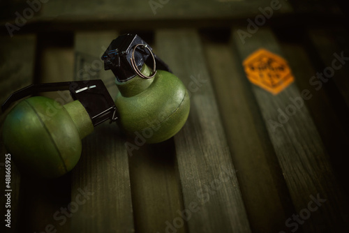explosive grenades on the background of a wooden weapon box photo