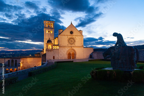 The Basilica Superiore of San Francesco in Assisi, with the statue of the Penitent Knight, at sunset
