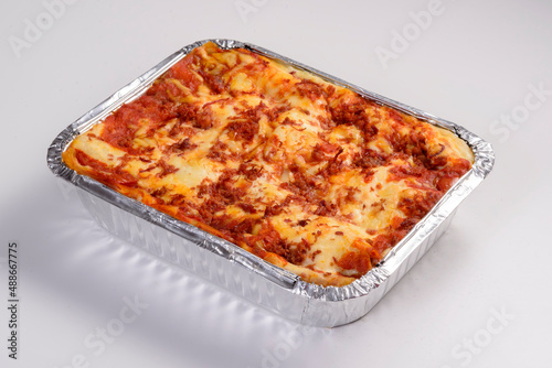 Lasagna delivery. Sun meat lasagna in packaging for delivery isolated on white background.