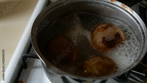 boiling potatoes into a cup 