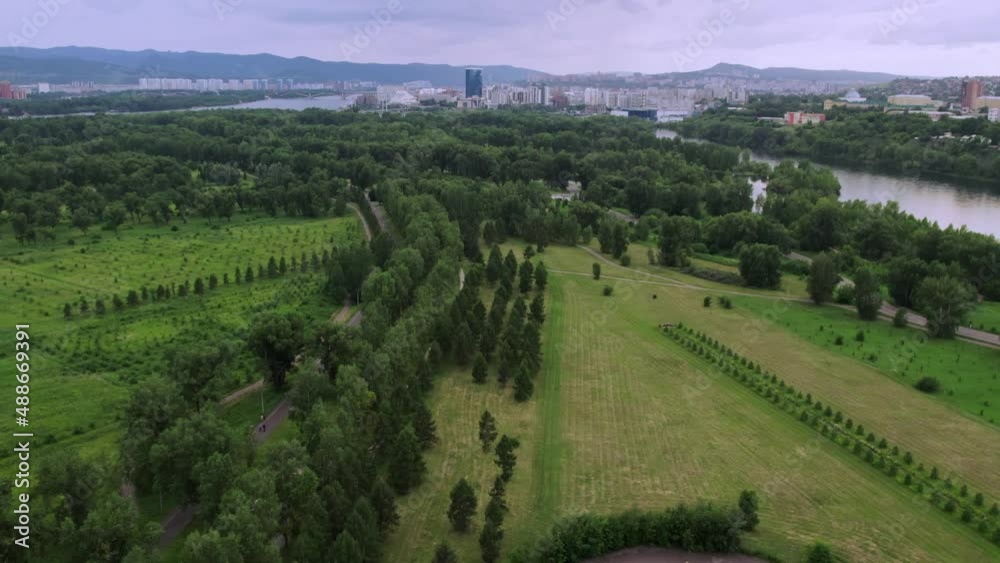 Big green park, in the distance you can see a big city, a drone flight Big green park, in the distance you can see a big city, a drone flight