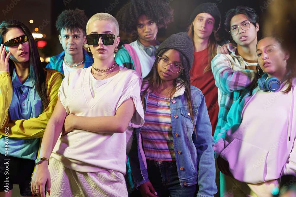 Modern teenager friends with trendy funky clothes in the city at night Modern teenager friends with trendy funky clothes in the city at night