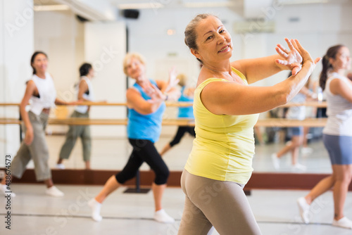 Active mature women enjoying training in dance studio, dance class for adults