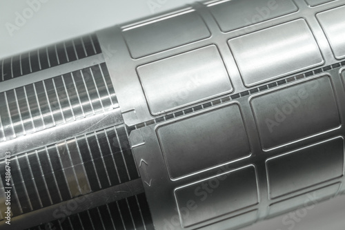 Used magnetic cylinder with attached flexible die for die cutting on rotary printing press. Die-cutting of labels. Cut knife for paper labels. Rotary stamp. Offset cutting knife for printing machine