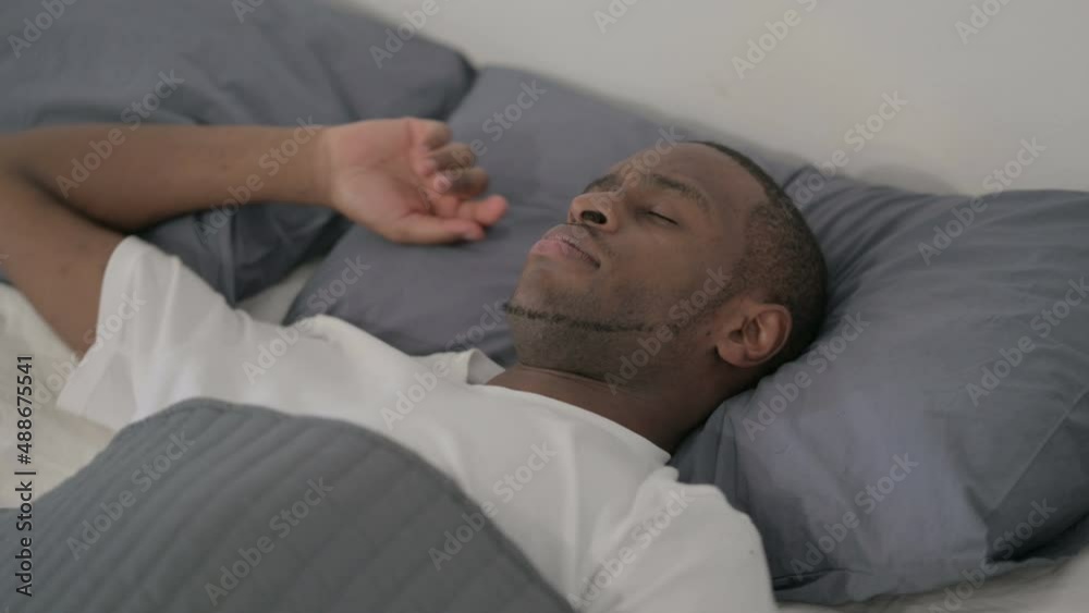 African Man Laying in Bed Unable to Sleep African Man Laying in Bed Unable to Sleep