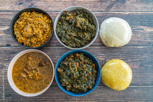 Egusi Ogbonno, Vegetable and Afang soup with pounded yam and Eba Garri photo