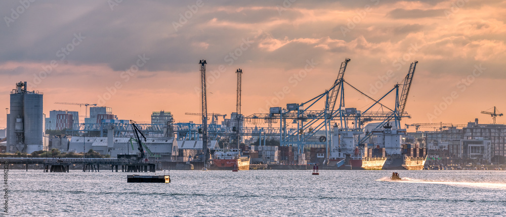Naklejka premium Dublin Harbor Port at sunset with cranes and ships 