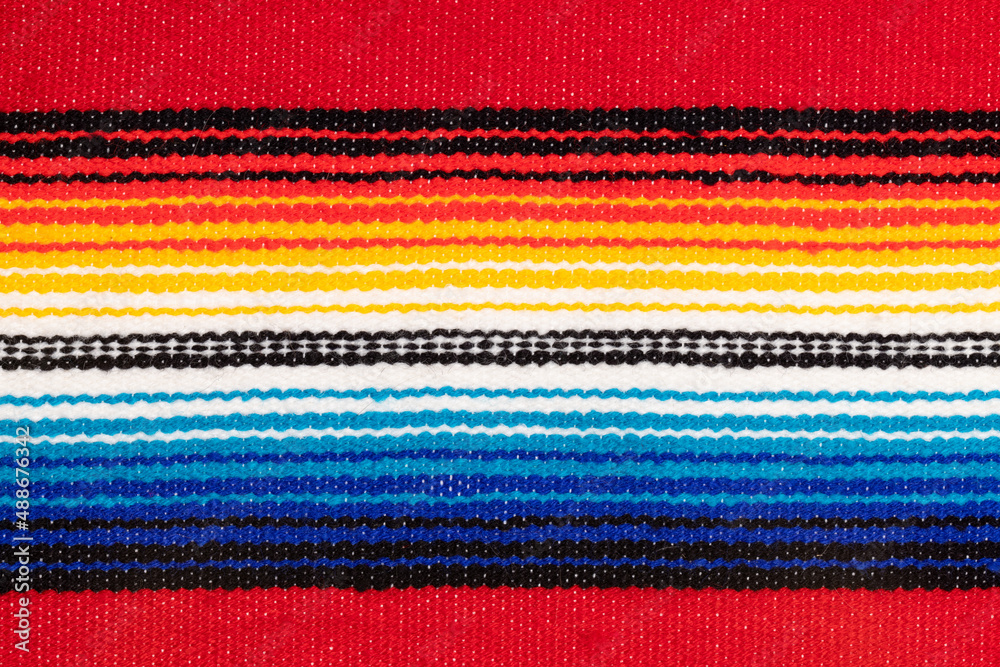 Traditional Colorful Mexican serape fabric, full background. Hand woven Latino blanket with specific vibrant colors.