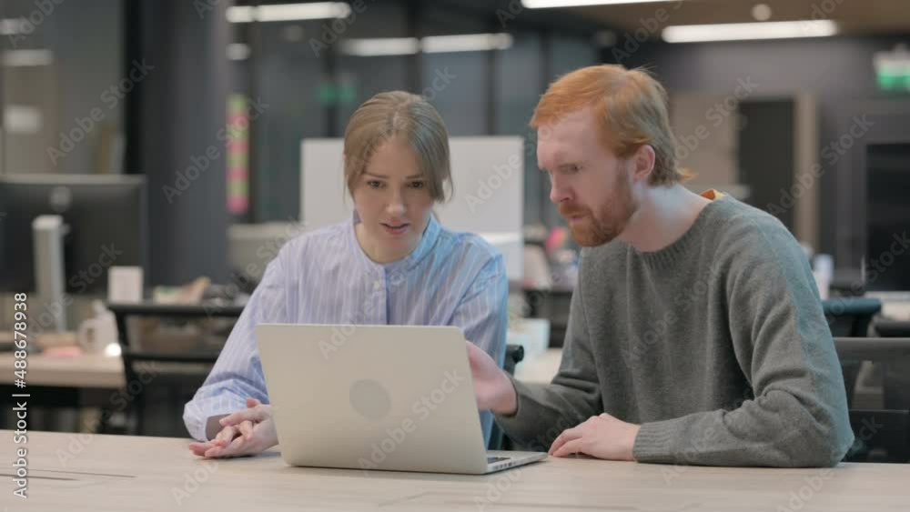 Young Man and Woman Reacting to Loss on Laptop 