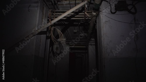 Scary dark underground deserted bunker walking with flashlight dangerous photo