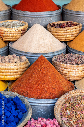 Arrangement of Moroccan spices, herbs and nuts and powder paint