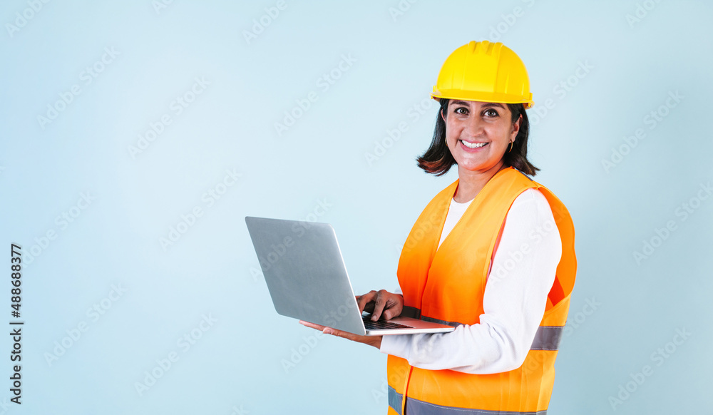 Hispanic woman Professional engineering and worker holding computer with helmet in Mexico Latin America Hispanic woman Professional engineering and worker holding computer with helmet in Mexico Latin America