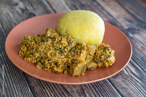 Nigerian Egusi Melon soup with garri eba for lunch photo