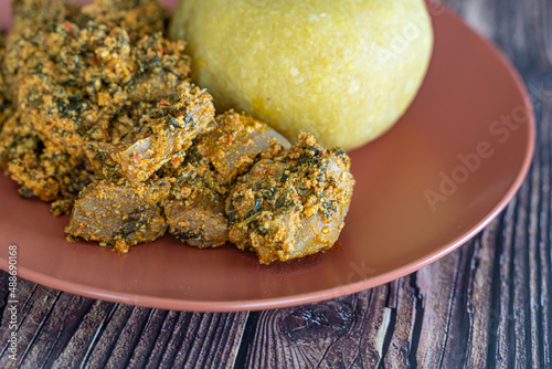 Nigerian Egusi Melon soup with garri eba for lunch photo