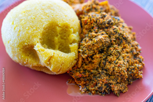 Nigerian Egusi Melon soup with garri eba for lunch photo