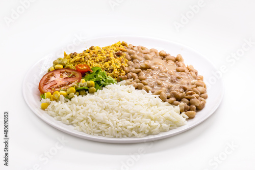 rice and beans dish, chopped tomato salad with corn and peas, on isolated white background, traditional brazilian meal