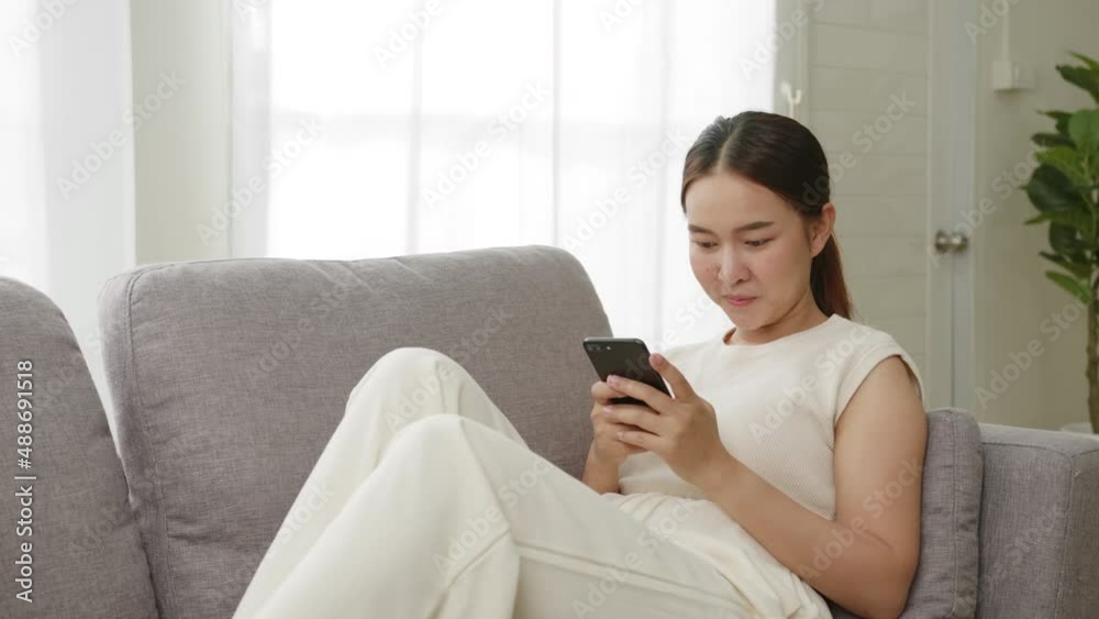 Young Asian beautiful woman using smart phone for business working, online shopping, transfer money, financial, internet banking at home, office Young Asian beautiful woman using smart phone for business working, online shopping, transfer money, financial, internet banking at home, office