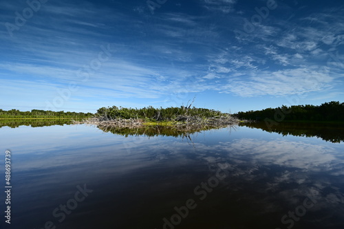 Morning clouds over Eco Pond in Everglades National Park, Florida reflected in pond's tranquil water.