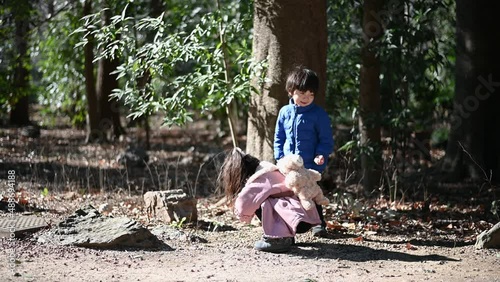 Boys and girls picking up nuts and playing